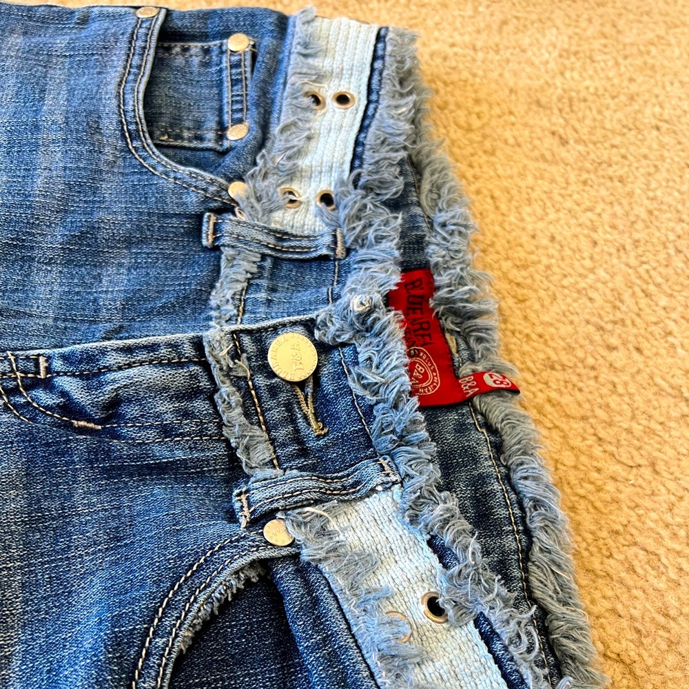 Low rise blue area jeans with a unique design!